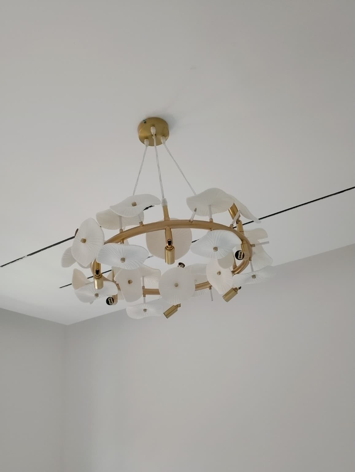 Installed chandelier fixture in a clean finished ceiling